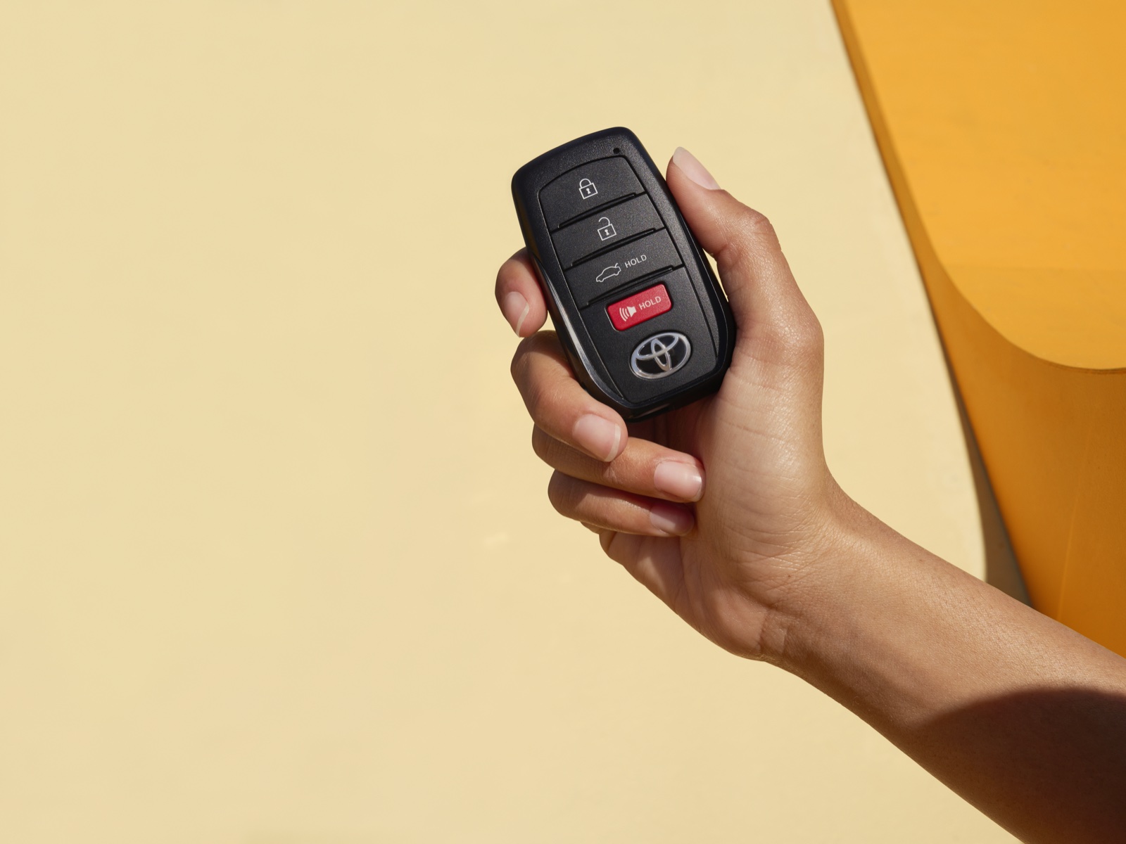 Hand holding a Toyota key fob